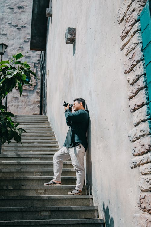 Free Man Holding Black Dslr Camera Stock Photo