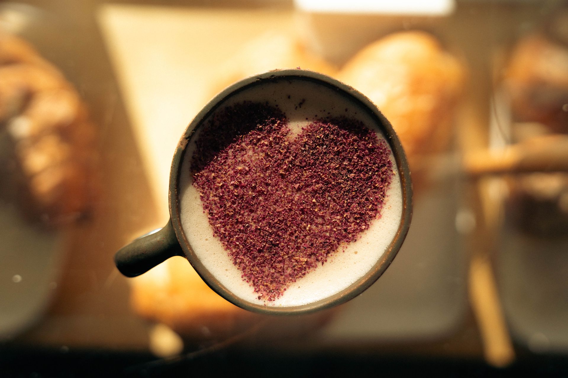 Cup of coffee with heart-shaped chocolate topping, a warm invitation to indulge.