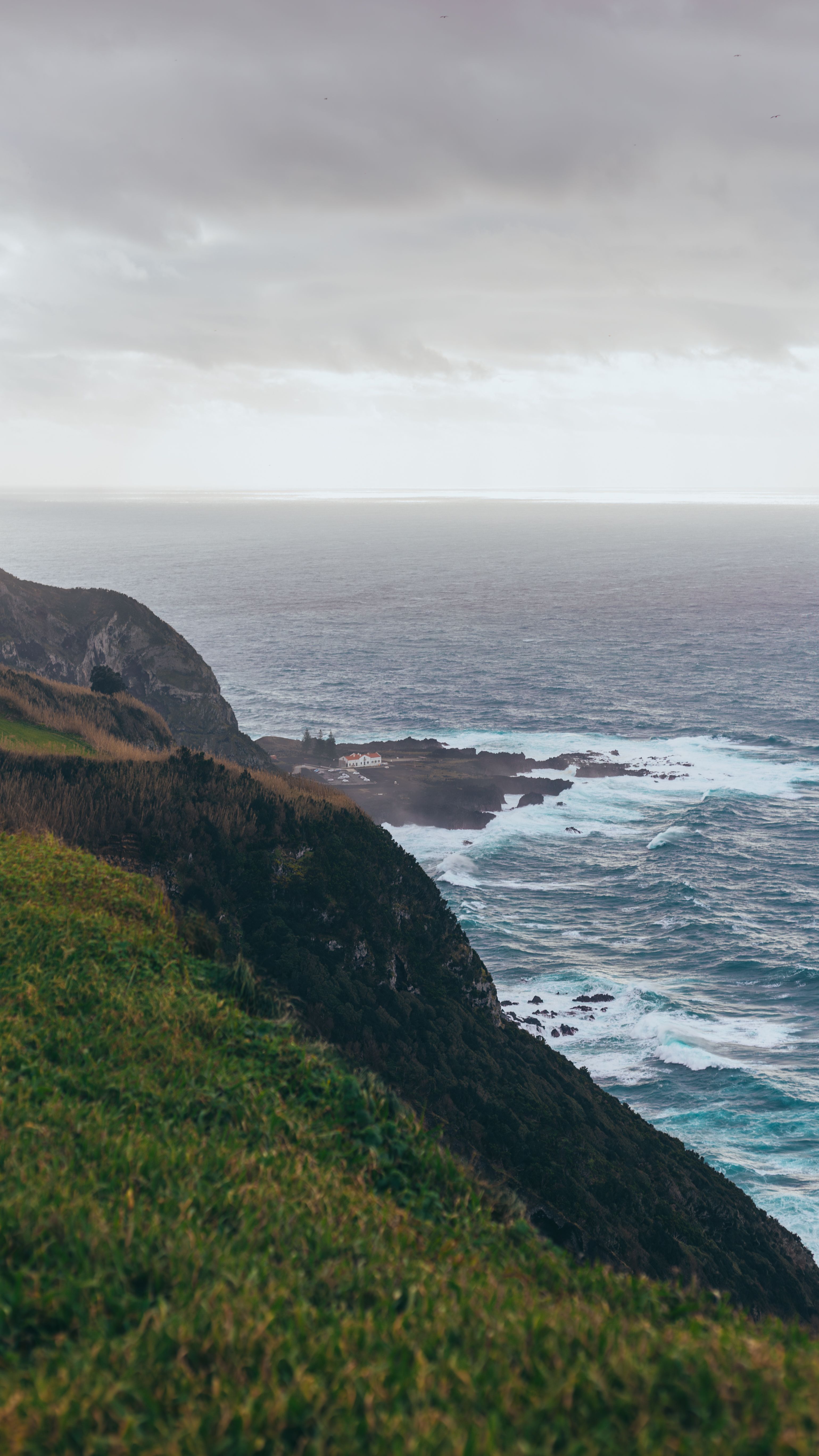 Coastal cliffs under a cloudy sky — photo by Artem Stoliar on Pexels