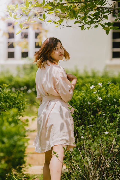 Woman Standing Near Green Field