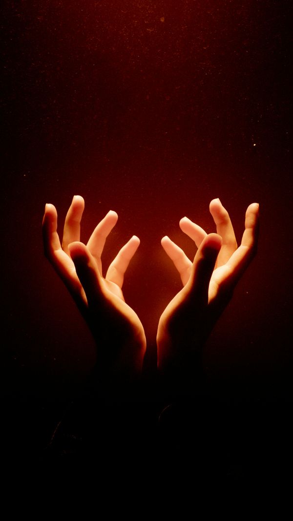 Illuminated healing hands with golden spiritual light