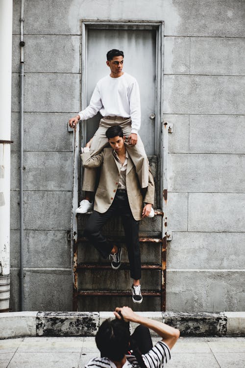 Photography of Man Carrying Another Man on Stairway