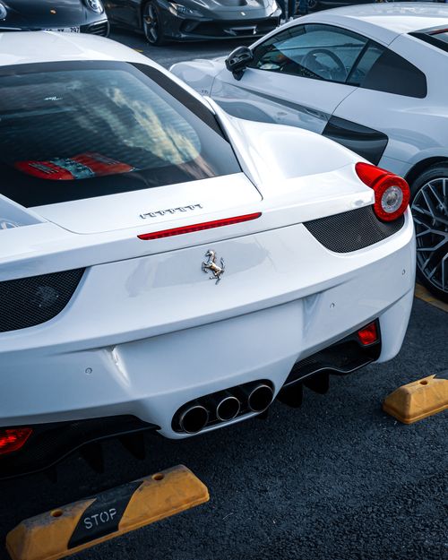 Free Close-up of sleek white luxury sports cars parked side by side, showcasing elegance and style. Stock Photo