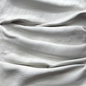Soft folds of white linen — photo by Natalia S on Pexels