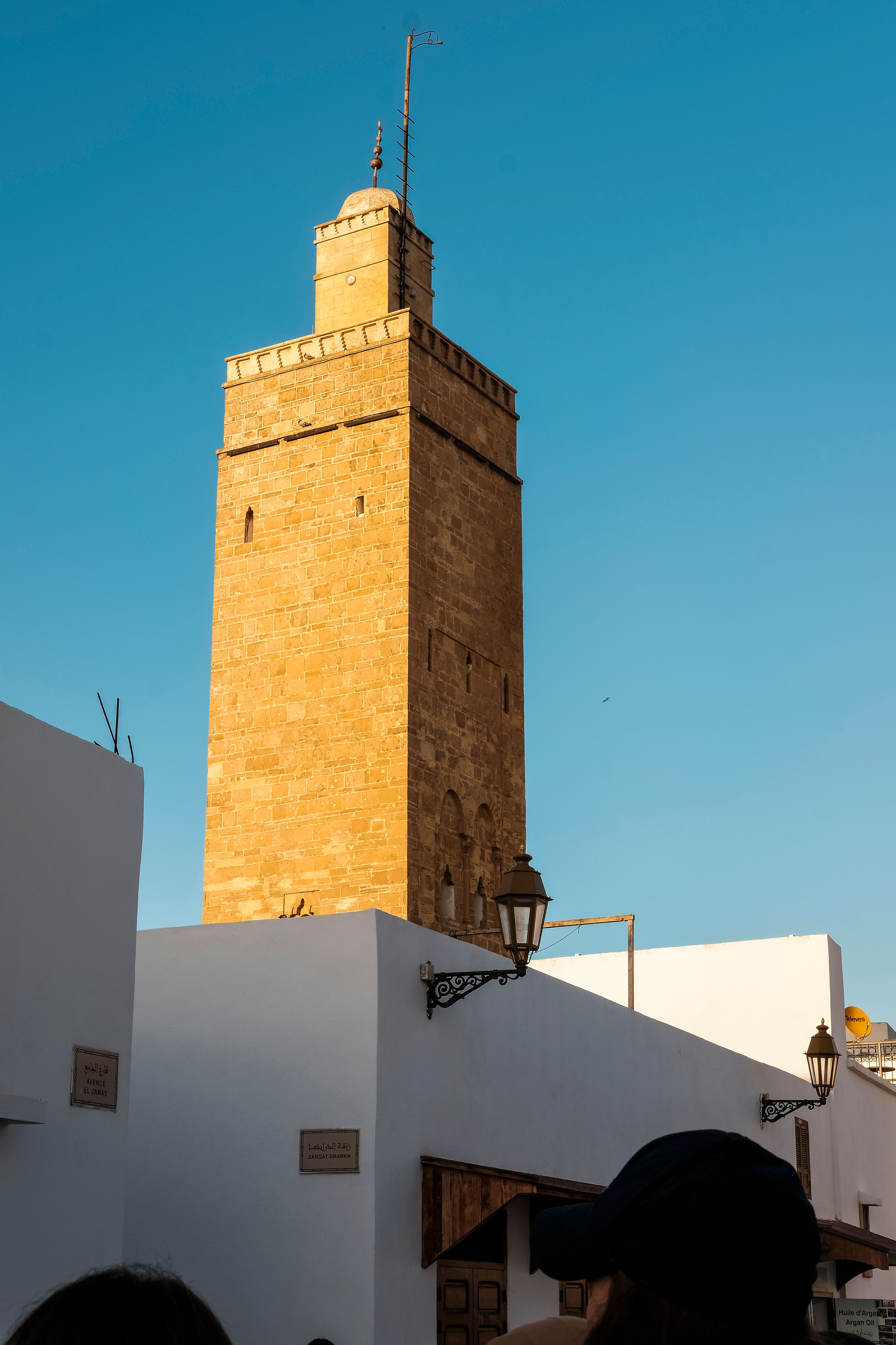 Majestic Hassan Tower under a clear blue sky in Rabat, Morocco, showcasing medieval architecture.