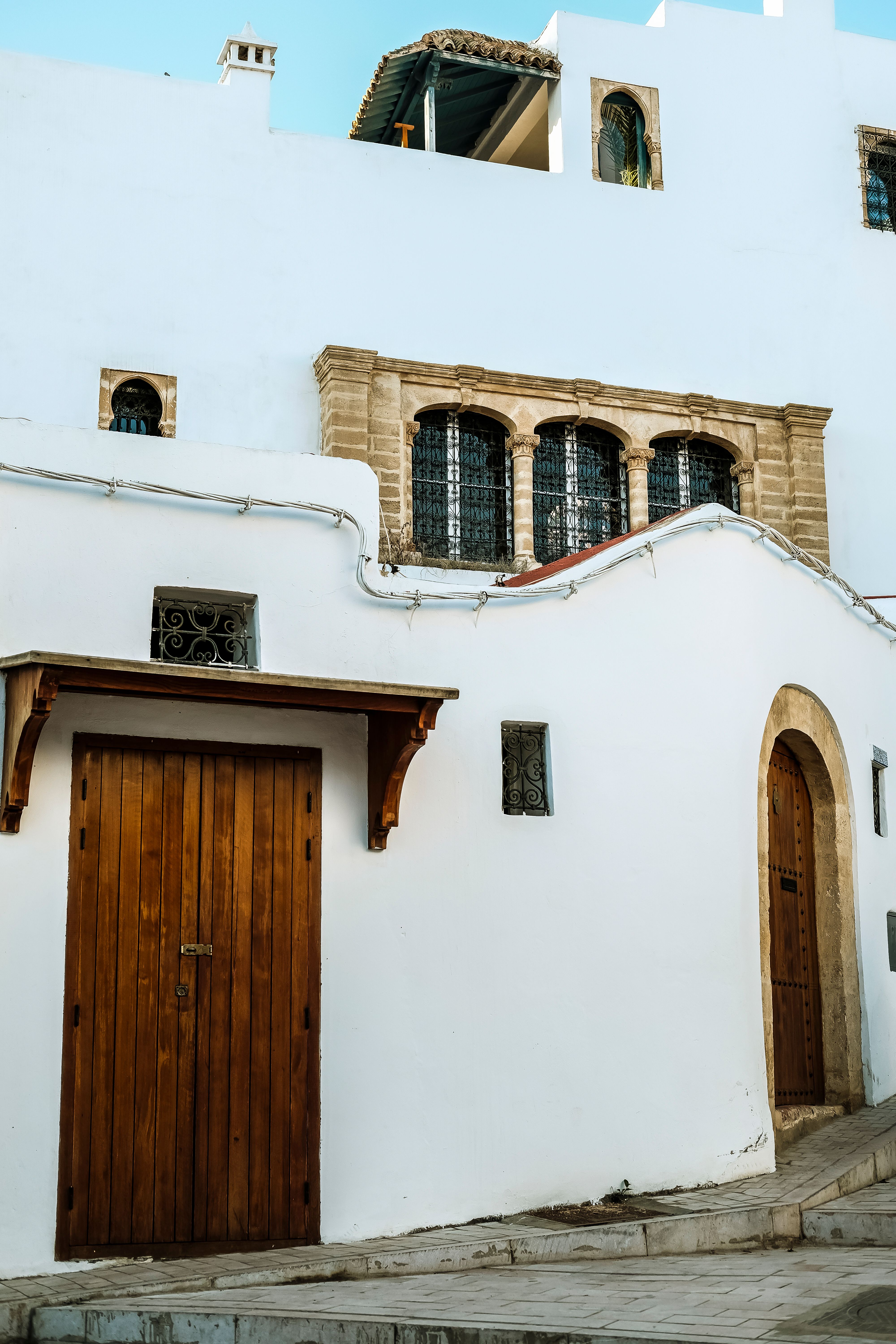 Historic building facade with wooden doors in Rabat's Old Medina, Morocco.