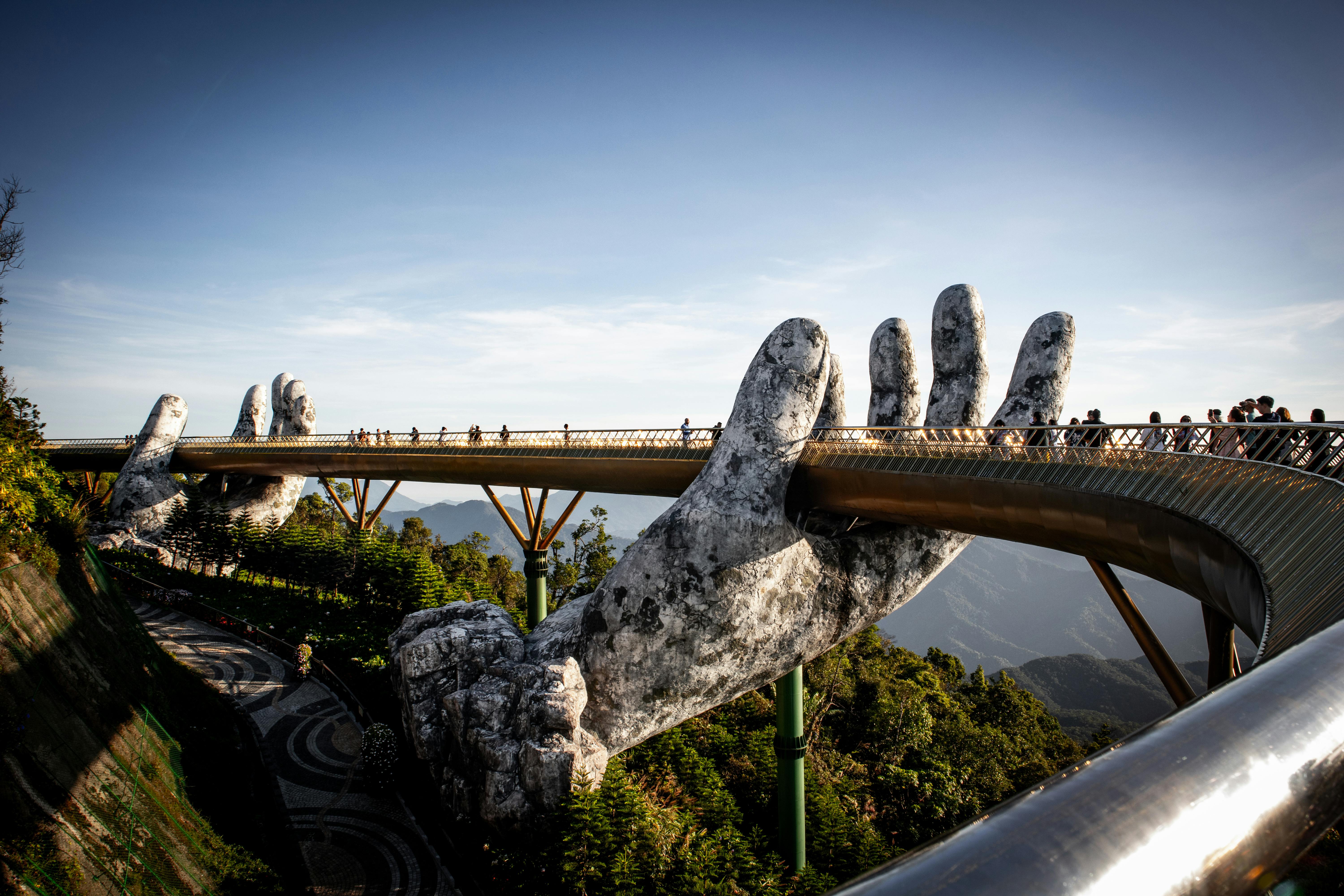 golden bridge held by giant hands in vietnam