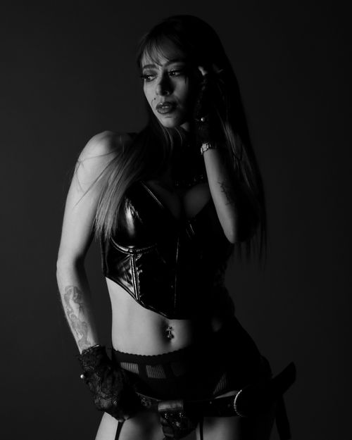 Free Moody black and white portrait of a woman wearing leather with tattoos. Stock Photo