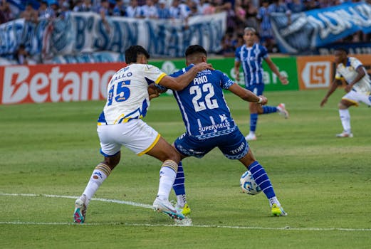 Soccer players in action during an intense match on a professional field.