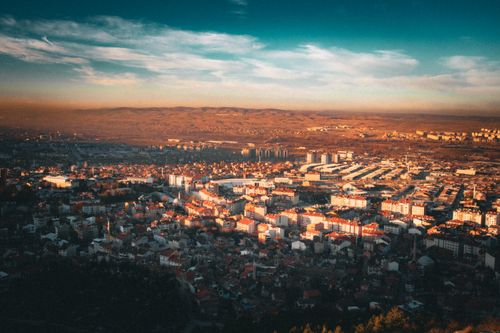 Free Aerial view of a cityscape during sunset with vibrant lighting. Stock Photo