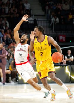 Basketball players in action during a game in Centre-Val de Loire, France.