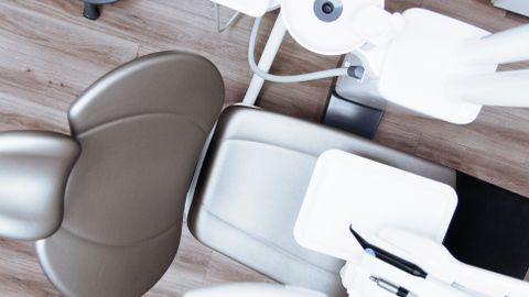High-angle view of a modern dental chair and equipment setup in a professional clinic.