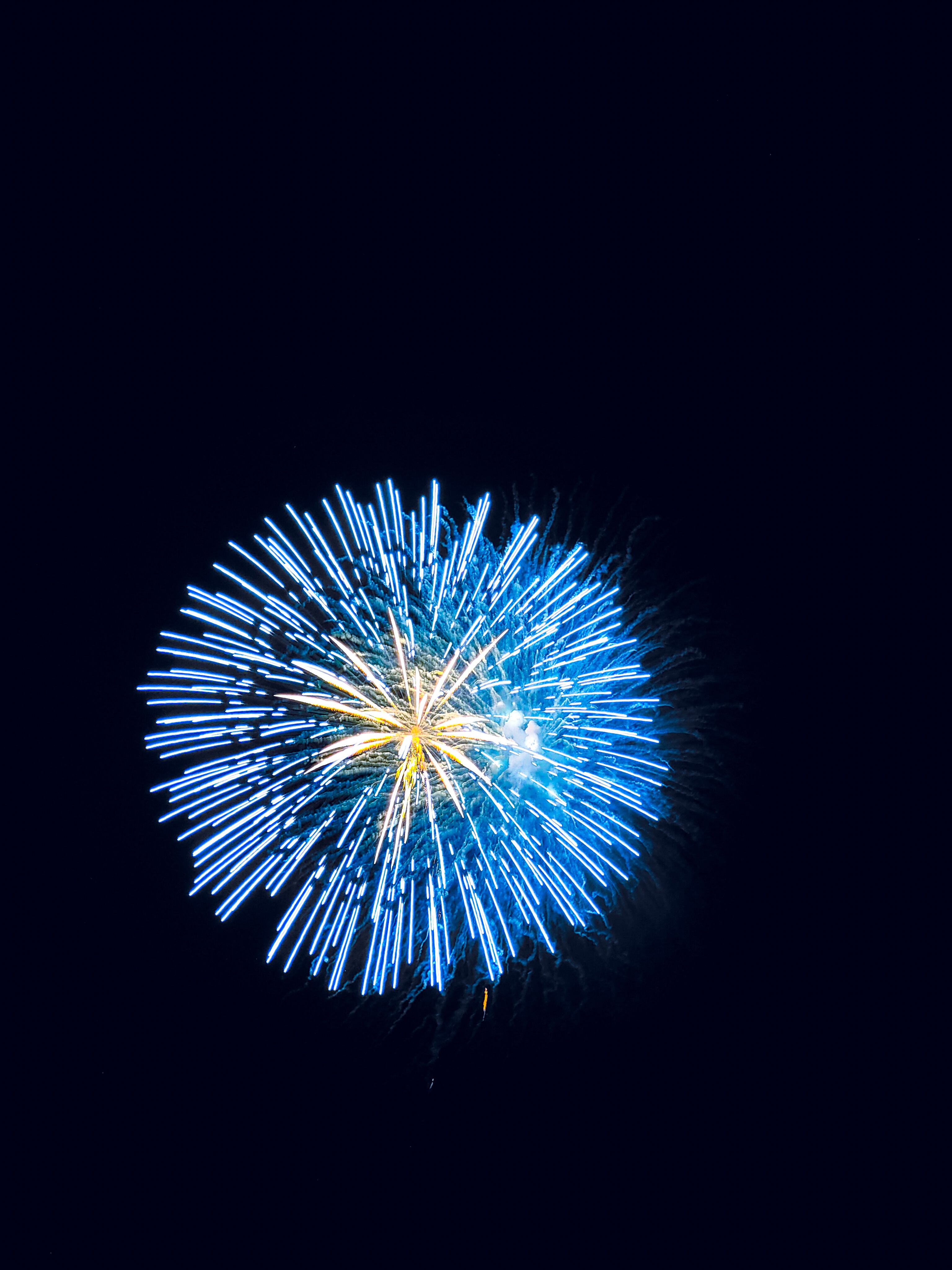 Bright blue fireworks illuminating the night sky in Japan, capturing a festive and vibrant atmosphere.