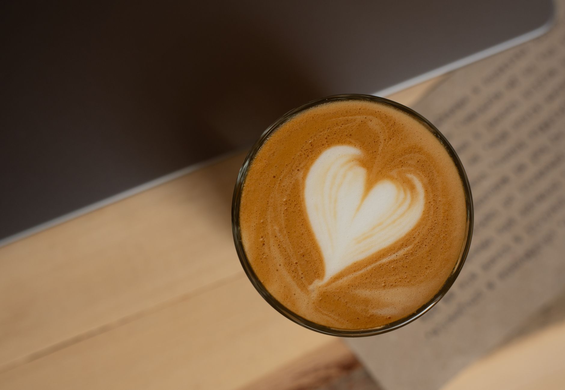 Top view of heart-shaped latte art on cappuccino, perfect for cozy mornings in Sabinov café.