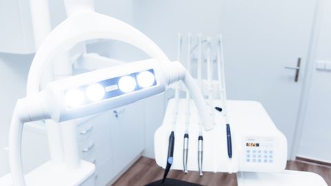 Bright and clean modern dental clinic room with advanced dental equipment.