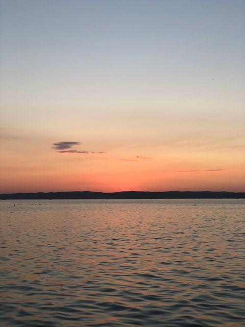 Free Beautiful sunset view over a calm lake, featuring warm colors and peaceful atmosphere. Stock Photo