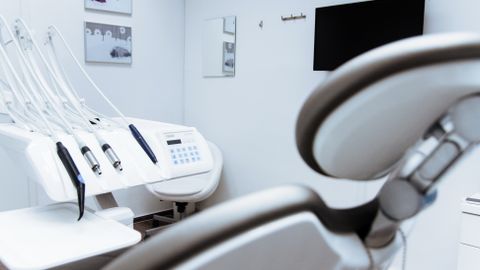 Bright dental office showcasing modern equipment and clean, sleek design.