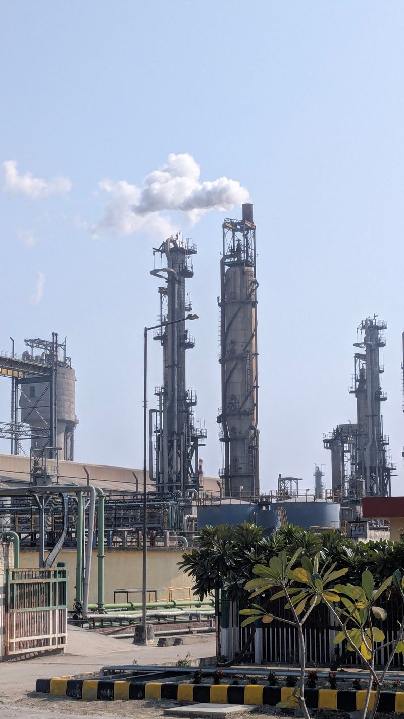 Chemical process plant against a clear sky representing technical bid analysis