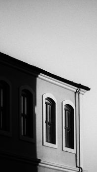 Elegant shadow play on a building's facade in black and white.