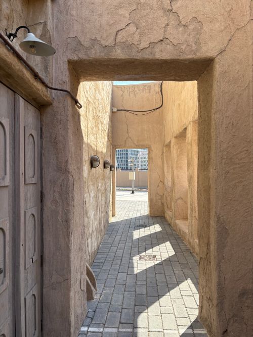 Free Explore the aged textures of Dubai's historic alleyways, capturing the essence of Middle Eastern architecture. Stock Photo