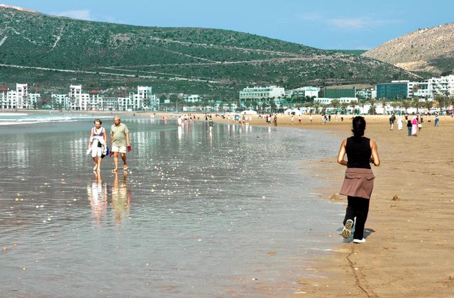 People enjoying a sunny day at a beautiful beach in Agadir, Morocco. — arriving in Agadir