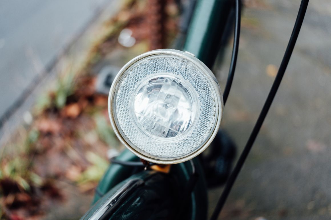 Close-up of a bicycle headlight mounted on an urban bike