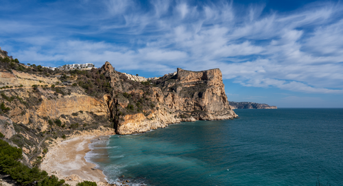 Free Beautiful coastal landscape of Benitachell, Spain with cliffs and turquoise sea under a bright blue sky. Stock Photo