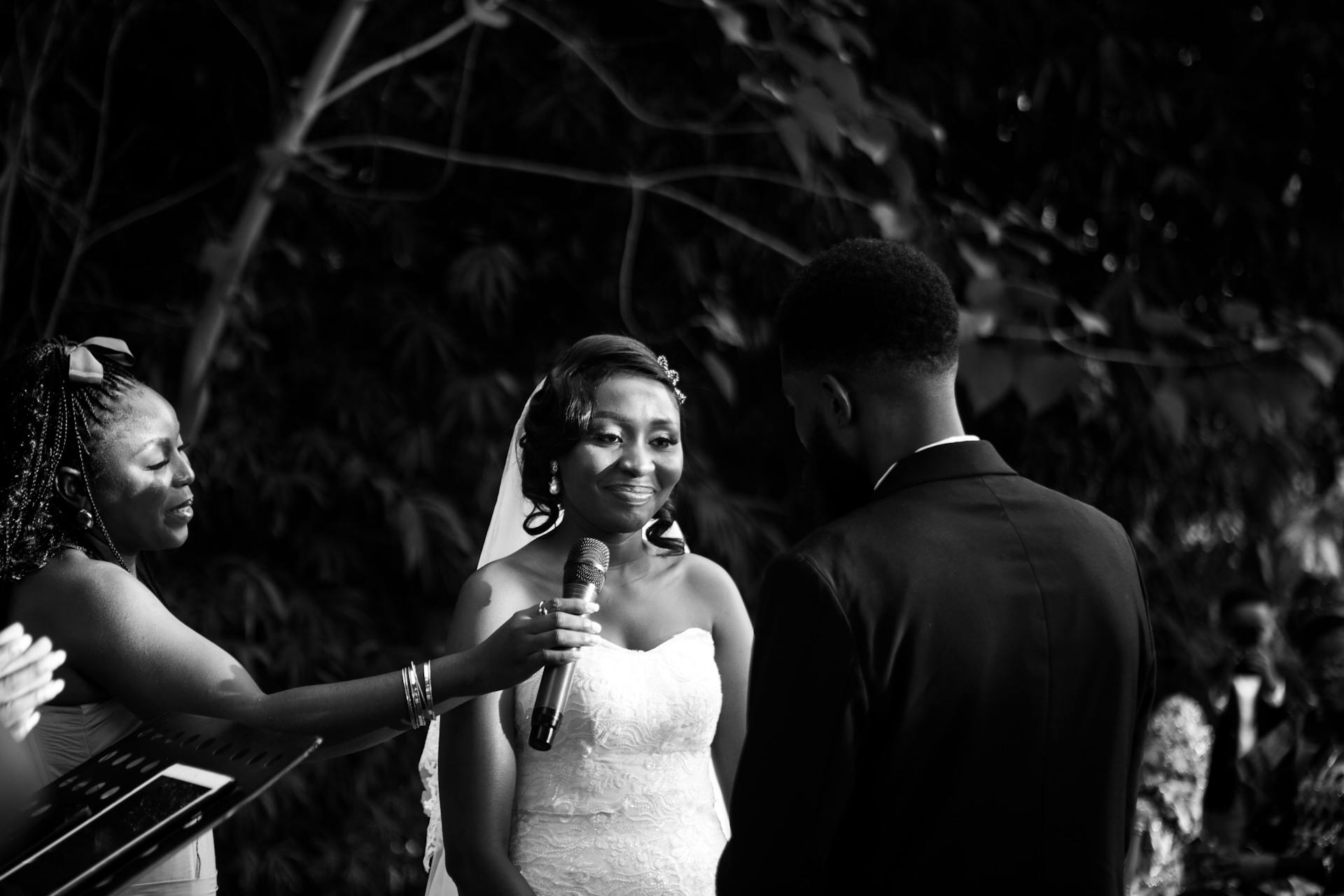 A beautiful black and white photo of a wedding ceremony outdoors, capturing a joyful moment.