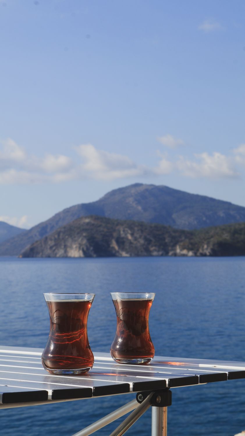 Tea Sea Scenic Tea Setup by Tranquil Seaside View · Free Stock Photo