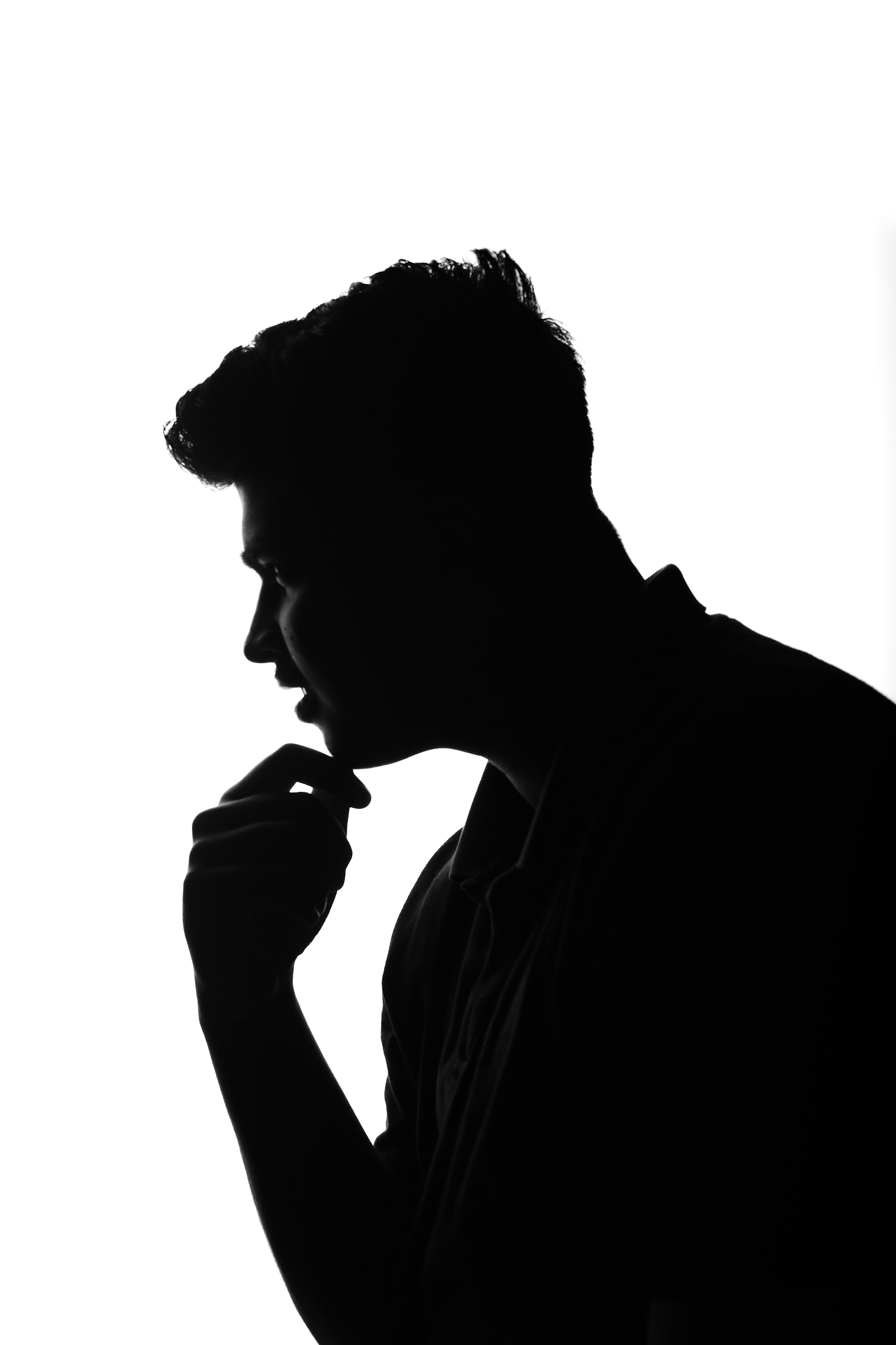 Silhouette of a Man Deep in Thought · Free Stock Photo
