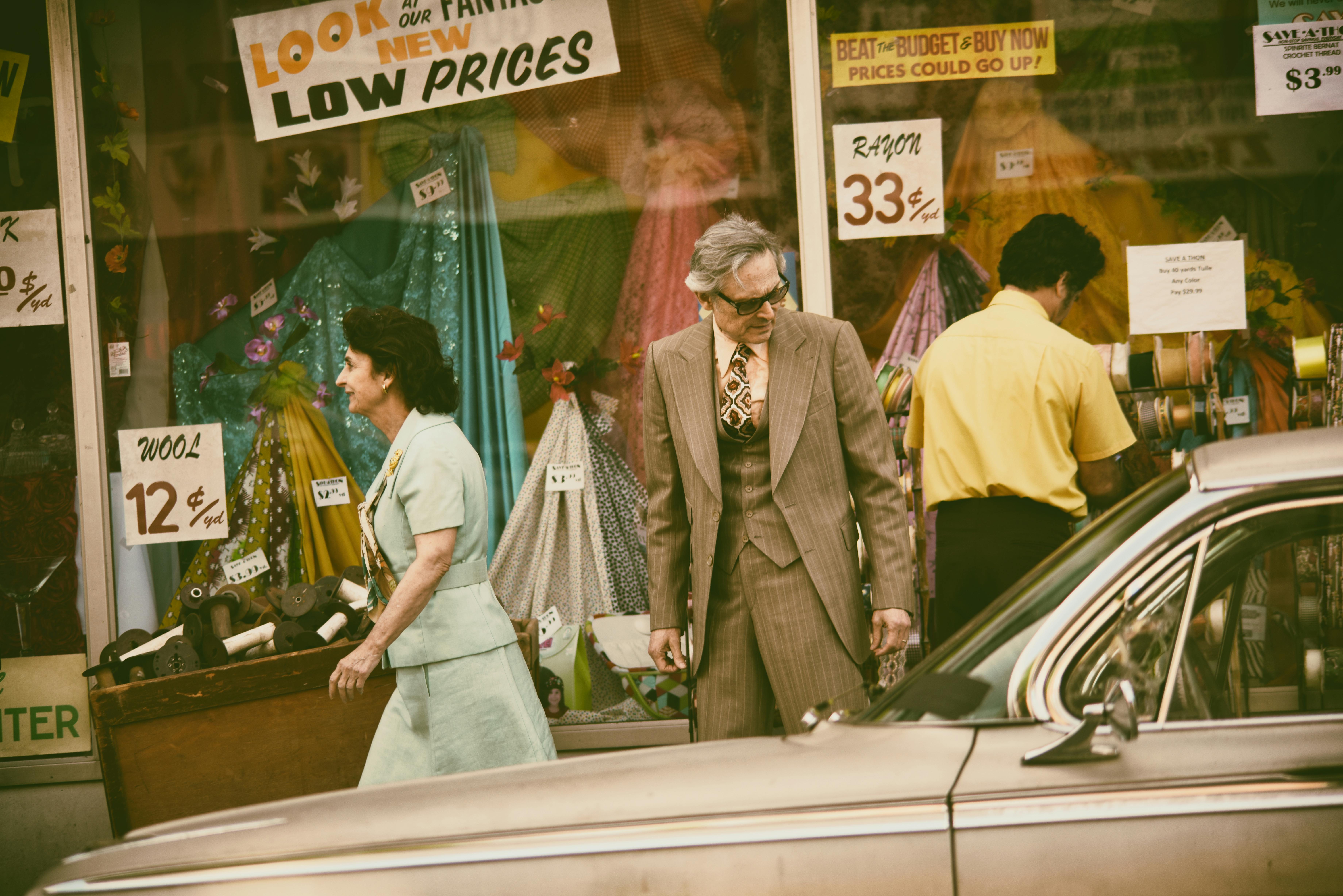 man looking at a vintage car