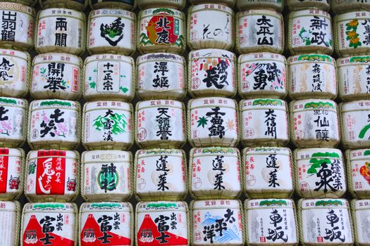 Decorative Japanese sake barrels stacked in Shibuya, Tokyo, Japan, showcasing traditional designs.