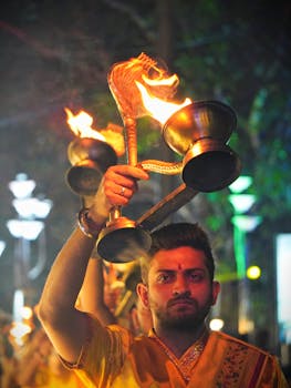 A man performs a traditional evening aarti ceremony in Kolkata, India.
