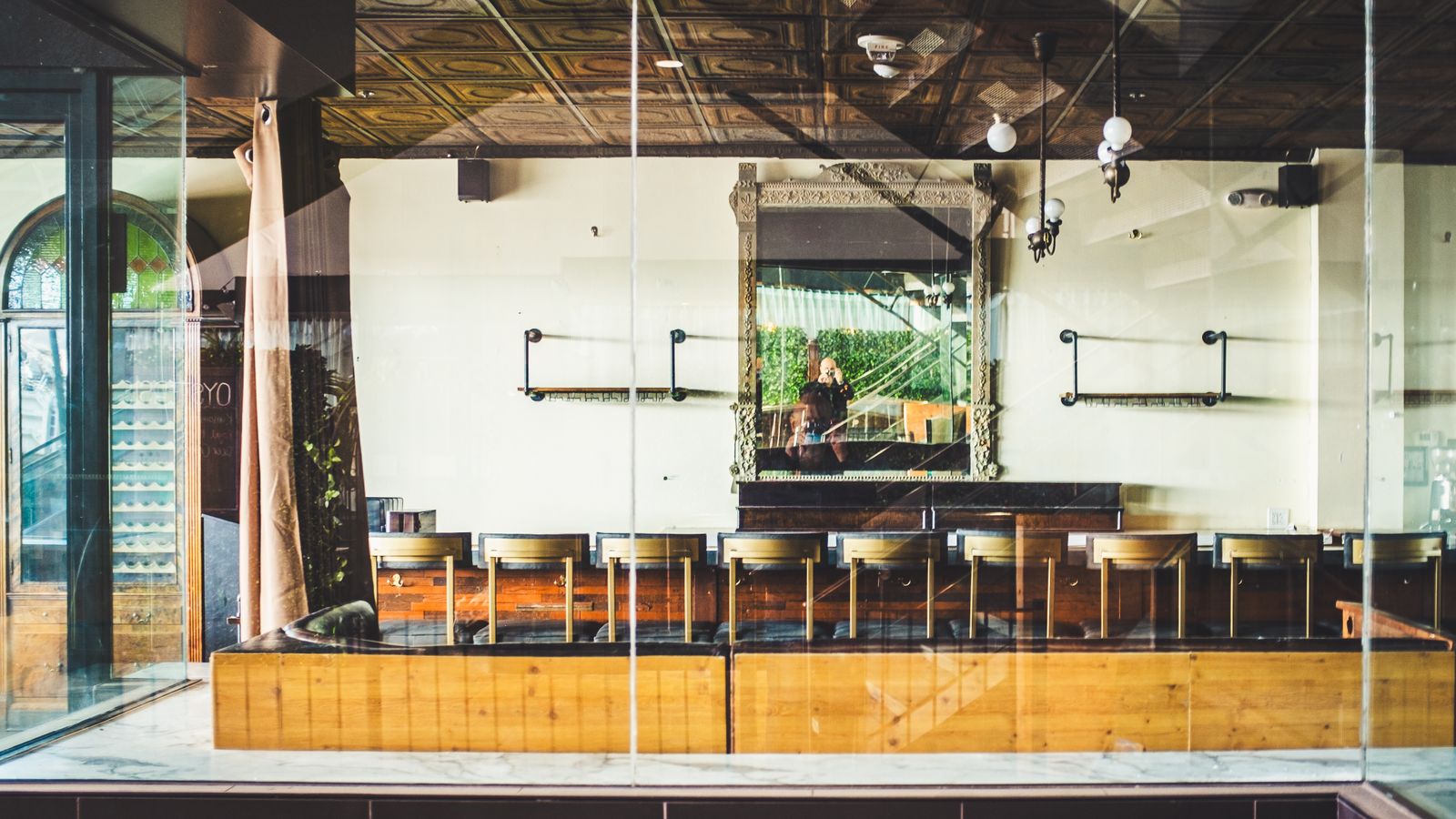 A modern cafe interior with a vintage mirror and wooden seating in Boise, Idaho.