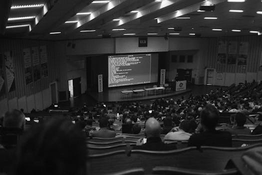 Black and white shot of a technology conference at ULB auditorium, Brussels.