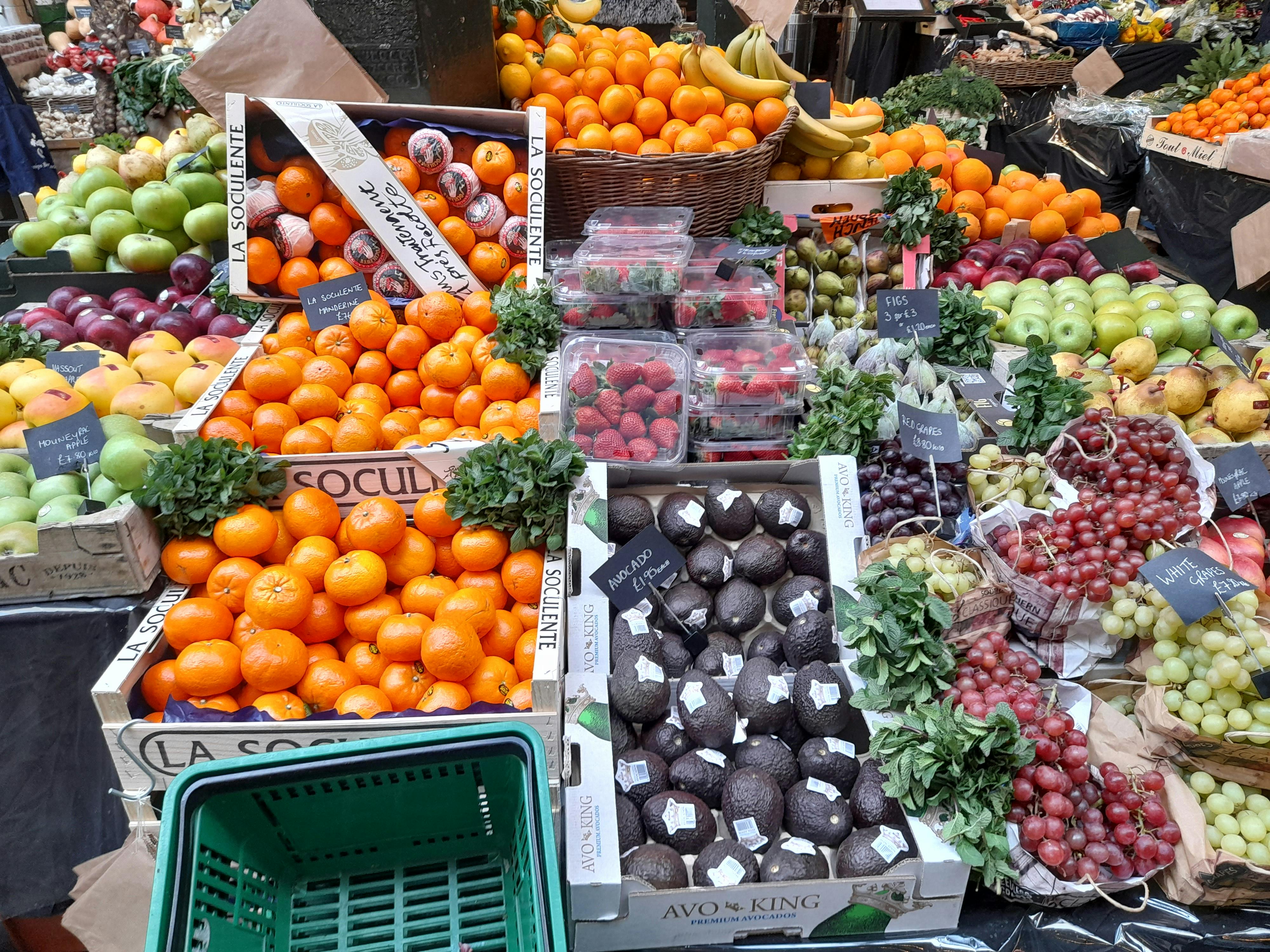 Free Vibrant display of fresh fruits and vegetables at a market stall in London. Stock Photo