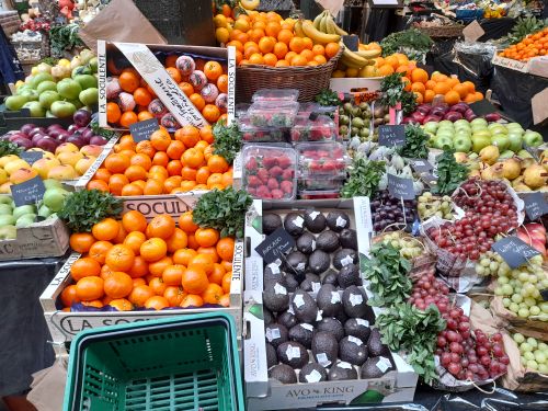 Free Vibrant display of fresh fruits and vegetables at a market stall in London. Stock Photo