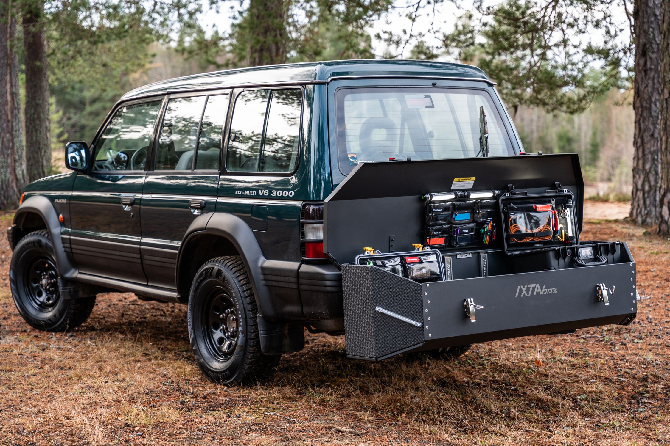Off-Road Vehicle with Custom Storage Solution in Forest · Free Stock Photo