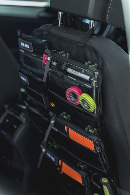 A multi-pocket car seat back organizer with colorful accessories for convenient storage