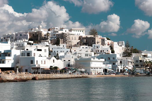 Scenic view of traditional white houses and azure sea in Naxos, Greece.