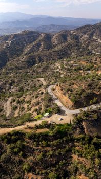 Stunning aerial view of Cyprus's rugged mountain landscape under clear skies.