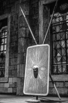 Vintage Roman shield and spears against an ancient stone wall in Istanbul.