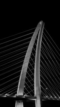Black and white photo of an iconic cable-stayed bridge at night in Ho Chi Minh City, Vietnam.