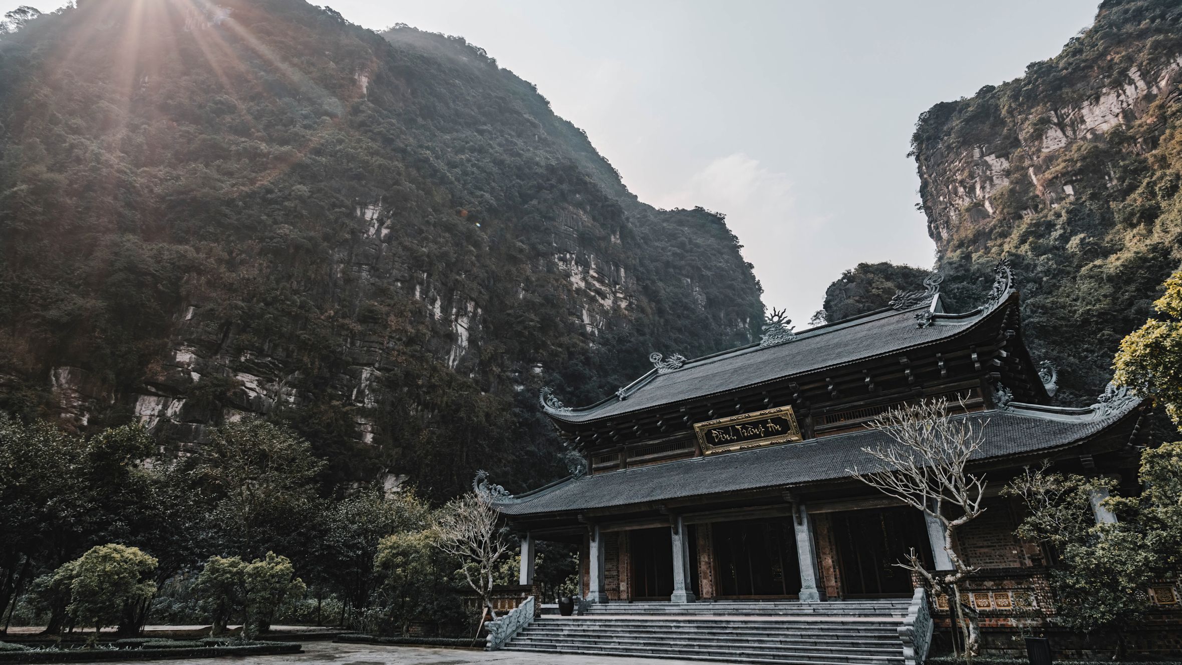 Breathtaking view of a Buddhist temple amidst stunning limestone mountains in Ninh Bình.