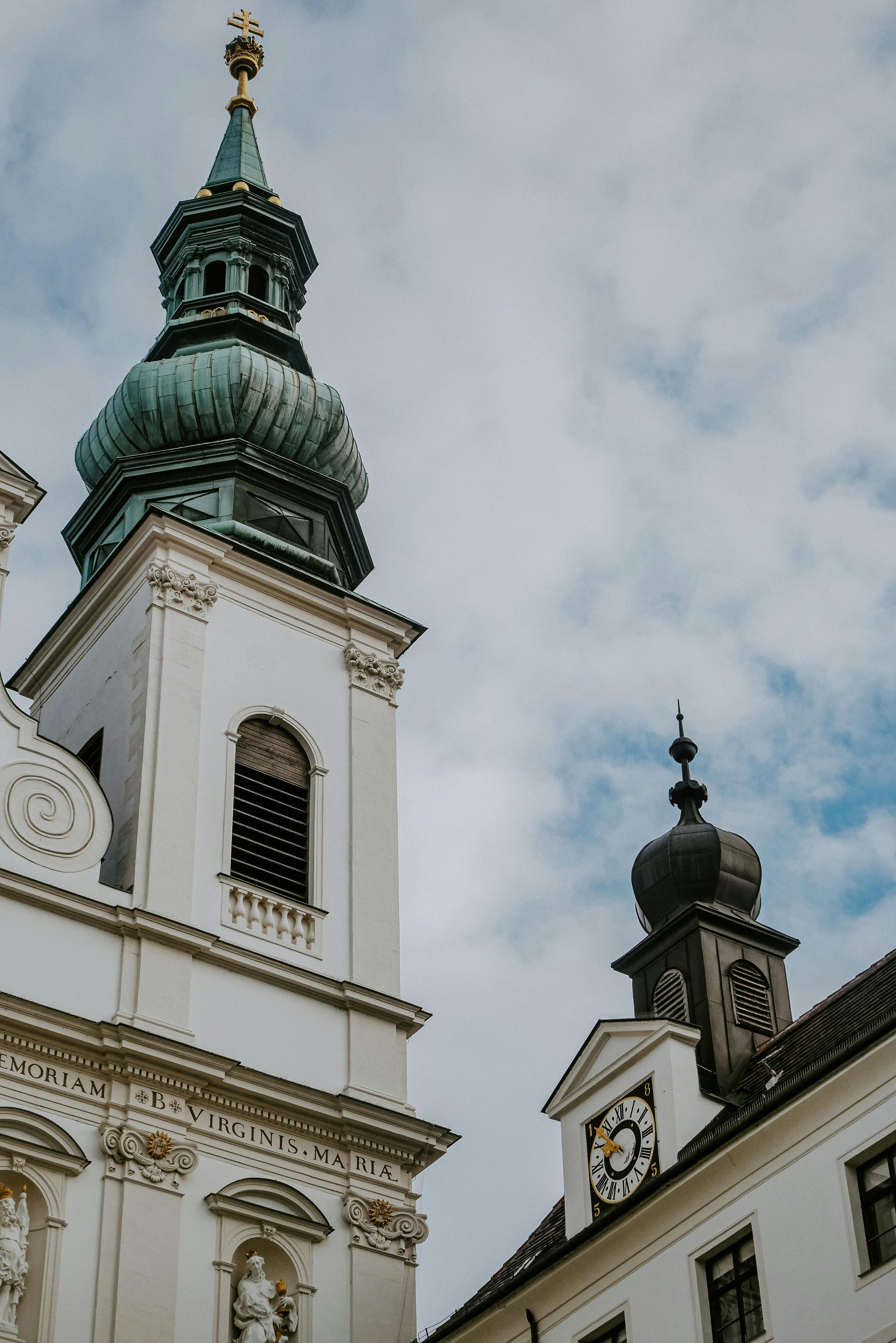 baroque architecture and clock tower against blue sky