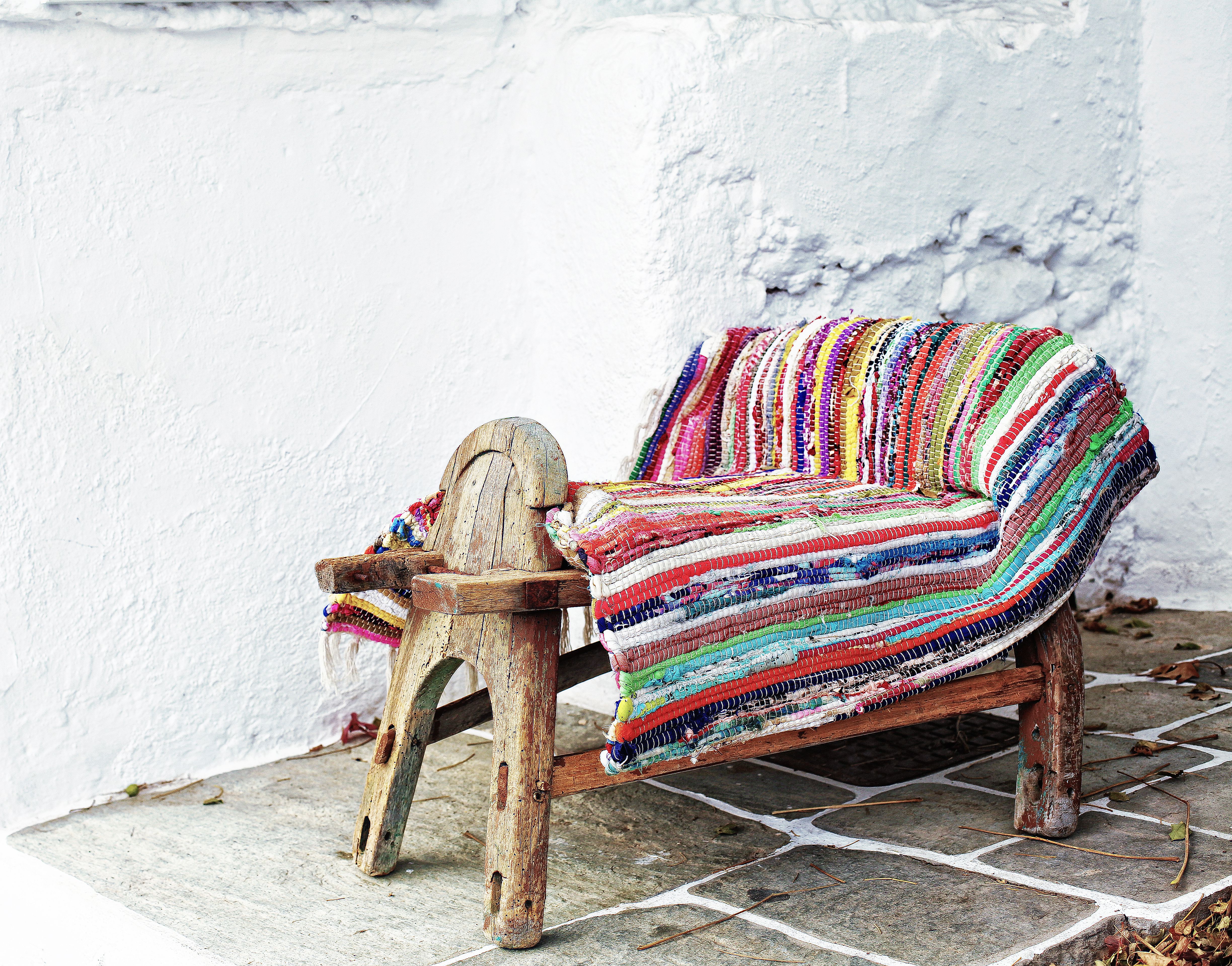 Colorful Rug on Wooden Chair against White Wall · Free Stock Photo