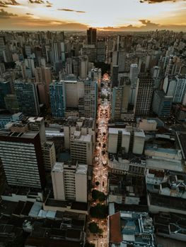 Dramatic aerial view of Curitiba's skyline captured at sunset, showcasing urban architecture.