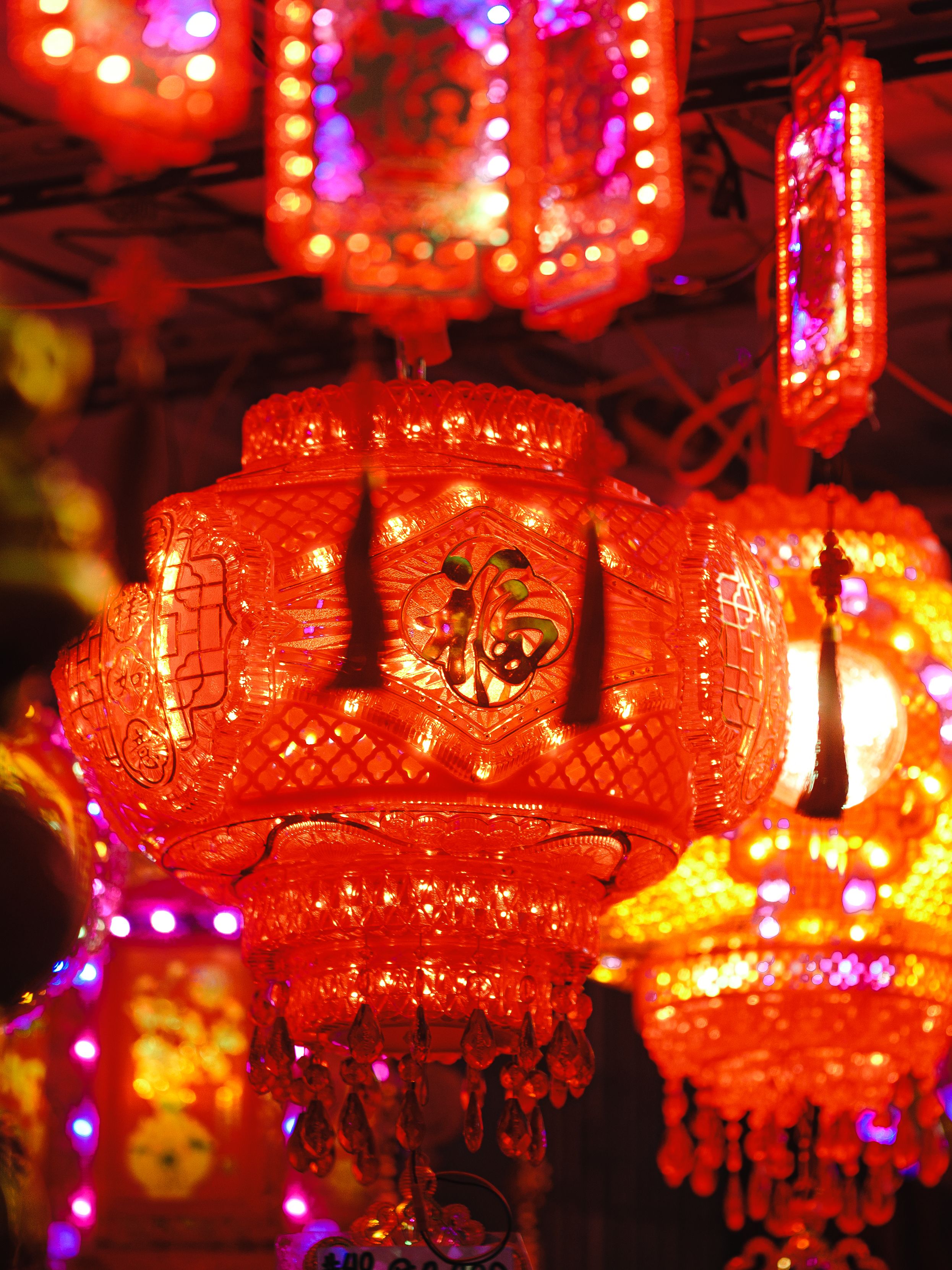 Colorful Chinese lanterns glowing brightly in night festival decor.