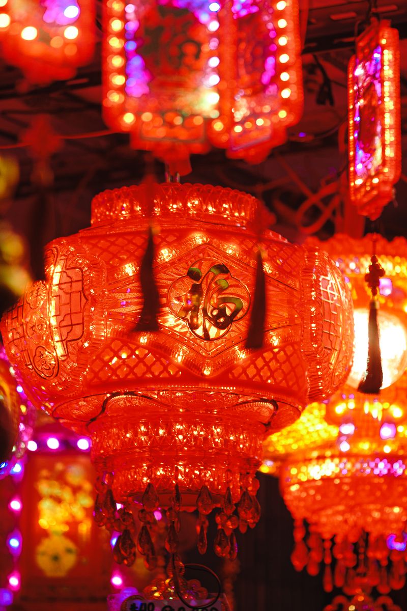 Colorful Chinese lanterns glowing brightly in night festival decor.