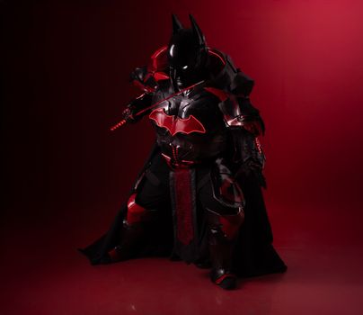 Striking black and red cosplay costume inspired by legendary hero, captured on a dramatic backdrop.